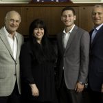 group photo of Gerstman family in office setting