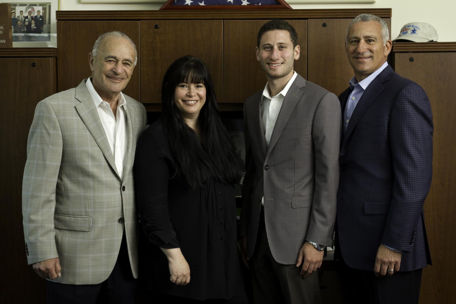 group photo of Gerstman family in office setting
