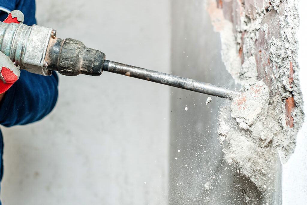 close up of heavy duty drilling into concrete facade