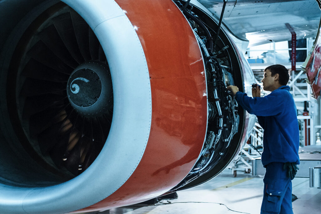 engineer repairing airplane engine